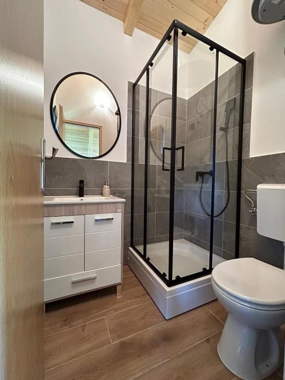Compact bathroom with glass shower, vanity and toilet