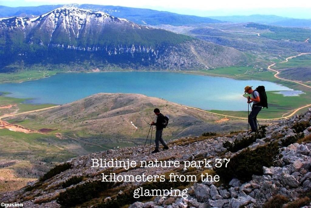 Hikers overlooking the lake and mountains in Blidinje Nature Park